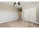 Spacious bedroom with plush carpet, neutral walls, ceiling fan and closet at 4975 Night Star Trl, Odessa, FL 33556