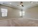 Spacious bedroom featuring neutral colors, a ceiling fan and ample natural light from multiple windows at 4975 Night Star Trl, Odessa, FL 33556