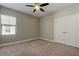 Cozy bedroom with plush carpet, neutral walls, ceiling fan, and window to create a comfortable retreat at 4975 Night Star Trl, Odessa, FL 33556