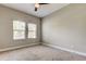 Bedroom featuring neutral colors, carpet, and natural light from multiple windows at 4975 Night Star Trl, Odessa, FL 33556