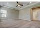 Bright bedroom features an arched doorway and a view of the ensuite bathroom and walk-in closet at 4975 Night Star Trl, Odessa, FL 33556