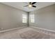 Bright bedroom with plush carpet, neutral walls, and window providing ample natural light at 4975 Night Star Trl, Odessa, FL 33556