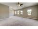 Spacious bonus room with multiple windows and a ceiling fan at 4975 Night Star Trl, Odessa, FL 33556