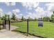 Fenced dog park with waste bag station and green space for pets to play at 4975 Night Star Trl, Odessa, FL 33556
