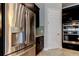 Close-up of a modern stainless steel refrigerator and sleek built-in ovens in a contemporary kitchen at 4975 Night Star Trl, Odessa, FL 33556
