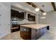Stylish kitchen with a large island, stainless steel appliances, and modern lighting fixtures at 4975 Night Star Trl, Odessa, FL 33556