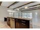 Bright kitchen island with a stainless steel dishwasher and dark wood cabinets beneath a marble countertop at 4975 Night Star Trl, Odessa, FL 33556
