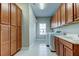 Laundry room features built-in cabinets, sink and appliances at 4975 Night Star Trl, Odessa, FL 33556