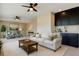 Comfortable living room with modern ceiling fans, a wet bar, and neutral tones creating a welcoming atmosphere at 4975 Night Star Trl, Odessa, FL 33556