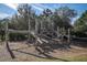Wooden playground structure offering a natural play area for children in the community at 4975 Night Star Trl, Odessa, FL 33556