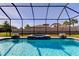 Inviting screened-in pool with waterfall features and a spa that overlooks the lush greenery of the backyard at 4975 Night Star Trl, Odessa, FL 33556
