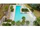 Overhead view of a large community pool with sun loungers and tropical landscaping at 4975 Night Star Trl, Odessa, FL 33556