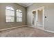 Bright room with plush carpeting, arched windows, and stylish glass french doors at 4975 Night Star Trl, Odessa, FL 33556