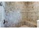 Shower featuring decorative tile walls, a built-in bench, and a rainfall shower head at 4975 Night Star Trl, Odessa, FL 33556
