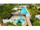 Aerial view featuring a splash pad and pool with lounge chairs, perfect for Gathering fun and relaxation at 4975 Night Star Trl, Odessa, FL 33556