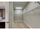 Walk-in closet featuring wire shelving and neutral carpet, offering ample storage space at 4975 Night Star Trl, Odessa, FL 33556