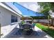 Outdoor dining area with a sunshade and a view of the backyard's spa at 512 Flamingo Dr, Apollo Beach, FL 33572