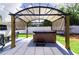 Backyard with a charming gazebo-covered hot tub, perfect for relaxation and entertainment at 512 Flamingo Dr, Apollo Beach, FL 33572