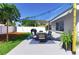 Outdoor dining area with a BBQ grill and a view of the landscaped backyard at 512 Flamingo Dr, Apollo Beach, FL 33572