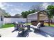 Inviting backyard features a seating area around a fire pit and covered hot tub, perfect for relaxing at 512 Flamingo Dr, Apollo Beach, FL 33572