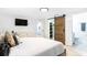 Comfortable bedroom featuring an en-suite bathroom, closet with sliding barn door, and light gray floors at 512 Flamingo Dr, Apollo Beach, FL 33572