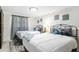 Well-lit bedroom featuring two beds, decorative wall art, and modern decor at 512 Flamingo Dr, Apollo Beach, FL 33572