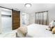 Bright bedroom with a sliding closet door, an ensuite bathroom, and sheer curtains at 512 Flamingo Dr, Apollo Beach, FL 33572