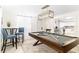 Game room includes a pool table, bar-height seating, and access to the kitchen for snacks at 512 Flamingo Dr, Apollo Beach, FL 33572