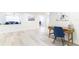 Open concept living area featuring wood floors, a desk, and a cozy sitting area at 512 Flamingo Dr, Apollo Beach, FL 33572