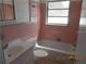 Retro bathroom featuring pink tiling, a bathtub, and a vanity sink offering functional space at 5318 7Th N Ave, St Petersburg, FL 33710