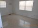 A bright bedroom features neutral walls and terrazzo floors, offering a simple and functional living space at 5318 7Th N Ave, St Petersburg, FL 33710