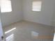 A bright bedroom features neutral walls and terrazzo floors, offering a simple and functional living space at 5318 7Th N Ave, St Petersburg, FL 33710
