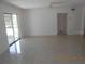 Bright living room with terrazzo floors, sliding glass doors, and neutral walls, offering a versatile living space at 5318 7Th N Ave, St Petersburg, FL 33710
