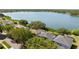 Aerial view of lakeside homes with mature trees and lush green lawns at 6607 Gates Pointe Way, Riverview, FL 33578