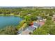 Birds-eye view of a home with a screened pool enclosure overlooking a lake and plenty of green space at 6607 Gates Pointe Way, Riverview, FL 33578