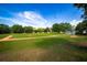 A beautifully maintained baseball field with lush green grass, set against a backdrop of trees and a bright blue sky at 6607 Gates Pointe Way, Riverview, FL 33578