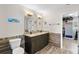 Bathroom features a double vanity with granite counters, tile backsplash, wood-look tile flooring, and walk-in closet at 6607 Gates Pointe Way, Riverview, FL 33578