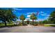 Inviting community center with palm trees and American flag under a bright blue sky at 6607 Gates Pointe Way, Riverview, FL 33578