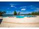 Resort-style community pool with plenty of lounge chairs and serene lake views at 6607 Gates Pointe Way, Riverview, FL 33578