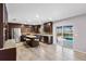 Modern kitchen with dark cabinets, stainless steel appliances, and an island bar at 6607 Gates Pointe Way, Riverview, FL 33578