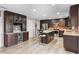 Kitchen with granite counters, a wine rack and cooler, and an island with seating at 6607 Gates Pointe Way, Riverview, FL 33578