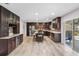 Spacious kitchen with stainless steel appliances, granite countertops, island and dark wood cabinets at 6607 Gates Pointe Way, Riverview, FL 33578
