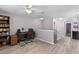Landing space with an office area, featuring built-in bookshelves and laminate floors at 6607 Gates Pointe Way, Riverview, FL 33578