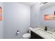 Stylish powder room features granite countertops, modern fixtures, and a decorative mirror at 6607 Gates Pointe Way, Riverview, FL 33578