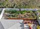 Aerial view of backyard with mature landscaping, a privacy fence, and an outdoor patio space at 708 Sandy Hills Ave, Tarpon Springs, FL 34689