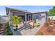 Backyard patio featuring well-manicured landscaping, seating, and a neutral colored exterior paint at 708 Sandy Hills Ave, Tarpon Springs, FL 34689