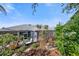The backyard has a patio, well-manicured landscaping and a neutral colored home exterior at 708 Sandy Hills Ave, Tarpon Springs, FL 34689