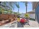 Backyard with fenced perimeter, seating, and well-manicured landscaping perfect for entertaining guests at 708 Sandy Hills Ave, Tarpon Springs, FL 34689