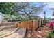 Backyard landscaping featuring stone pavers, a tiered stone wall, and privacy fence, a serene outdoor escape at 708 Sandy Hills Ave, Tarpon Springs, FL 34689