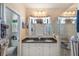 Bathroom with double sinks, granite countertop, decorative mirrors and glass enclosed shower at 708 Sandy Hills Ave, Tarpon Springs, FL 34689